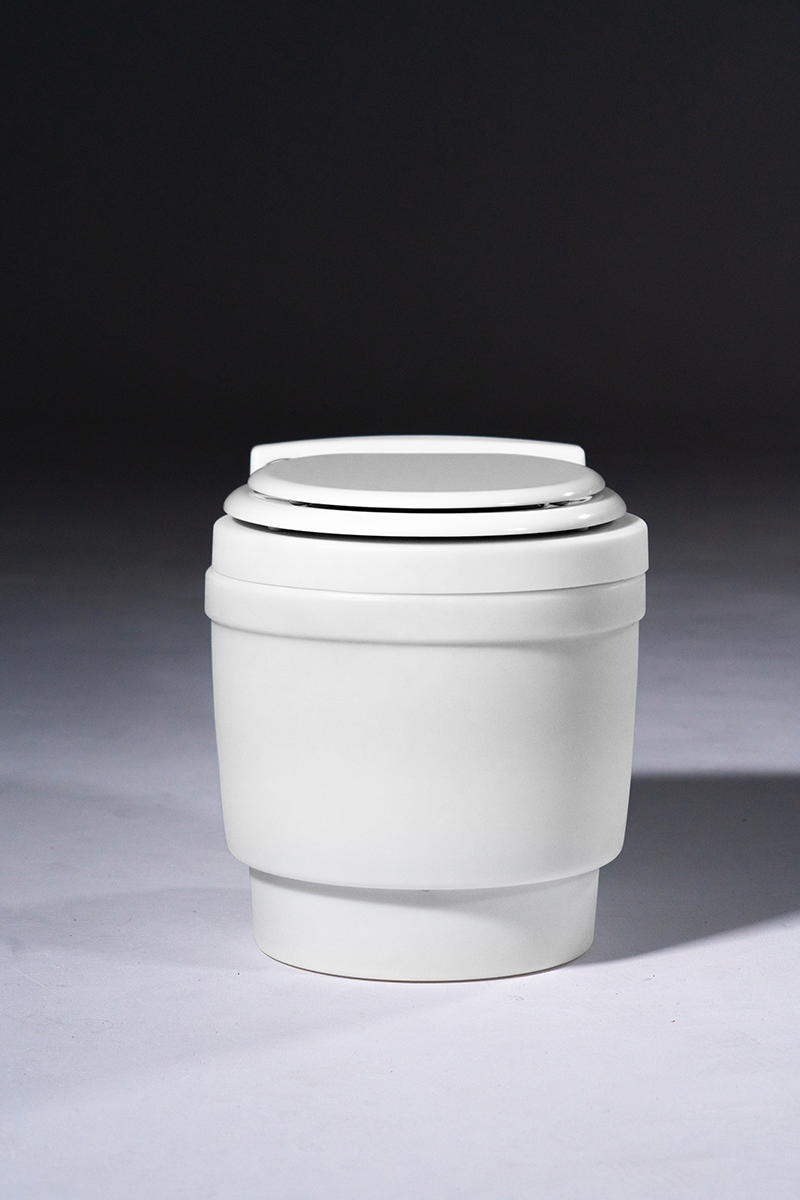 Laveo Dry Flush Closed, viewed from a side angle on Studio Background